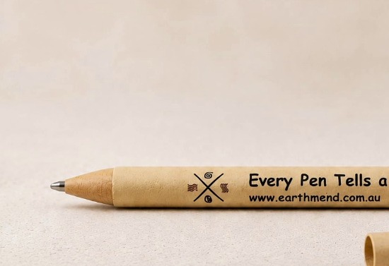 The EarthMend pen resting on a kraft-paper surface