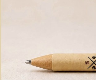 Close-up of the EarthMend pen's kraft-paper barrel and writing tip